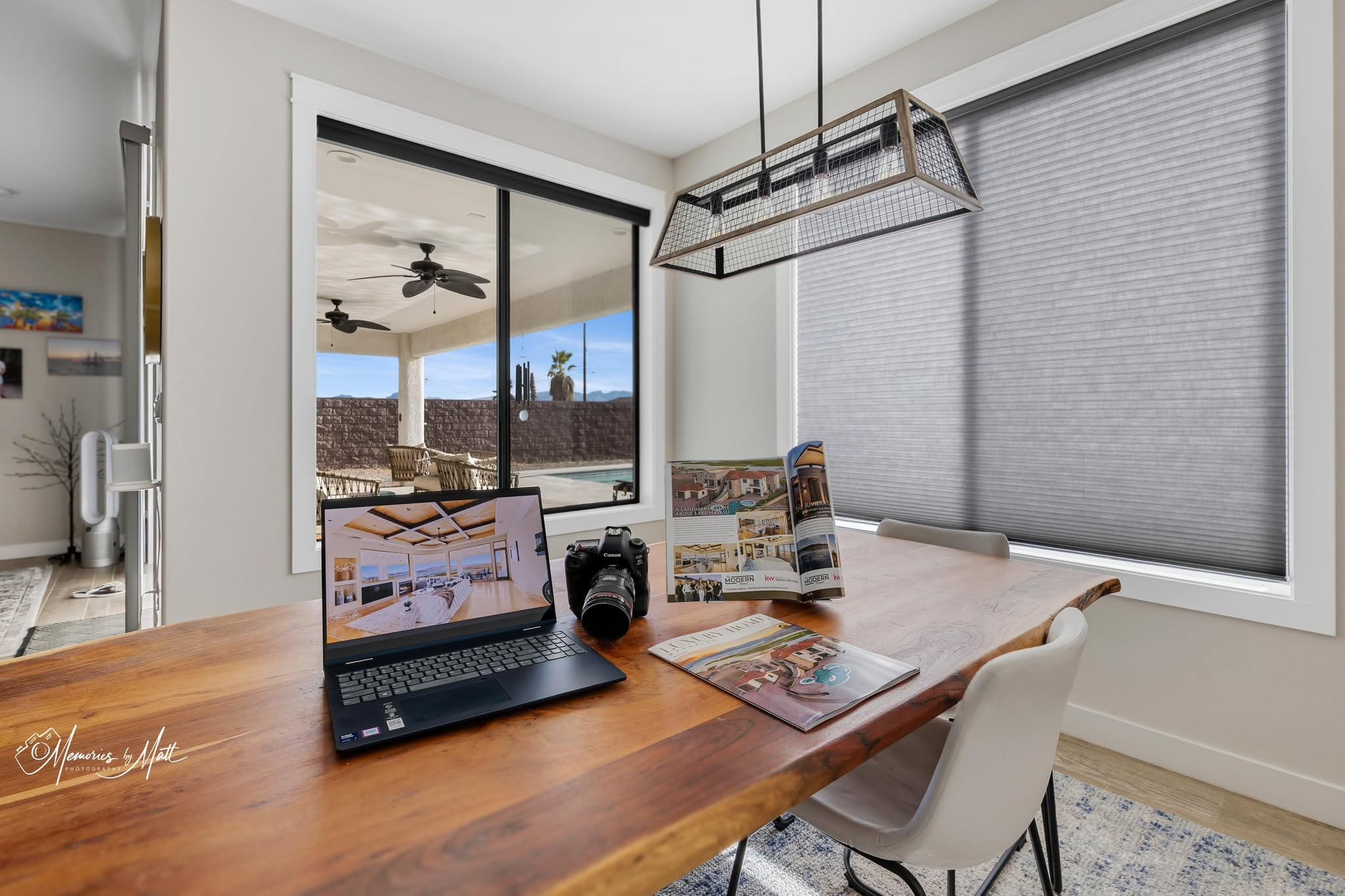 Laptop displaying Matt's real estate photography, a Canon camera, and a physical copy of Luxury Home Magazine Arizona on a table